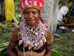 Smiling woman with shell necklace and feather headdress at Mount Hagen Sing Sing