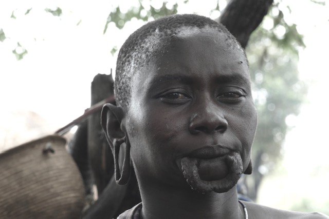 Mursi woman with lip plate removed for comfort