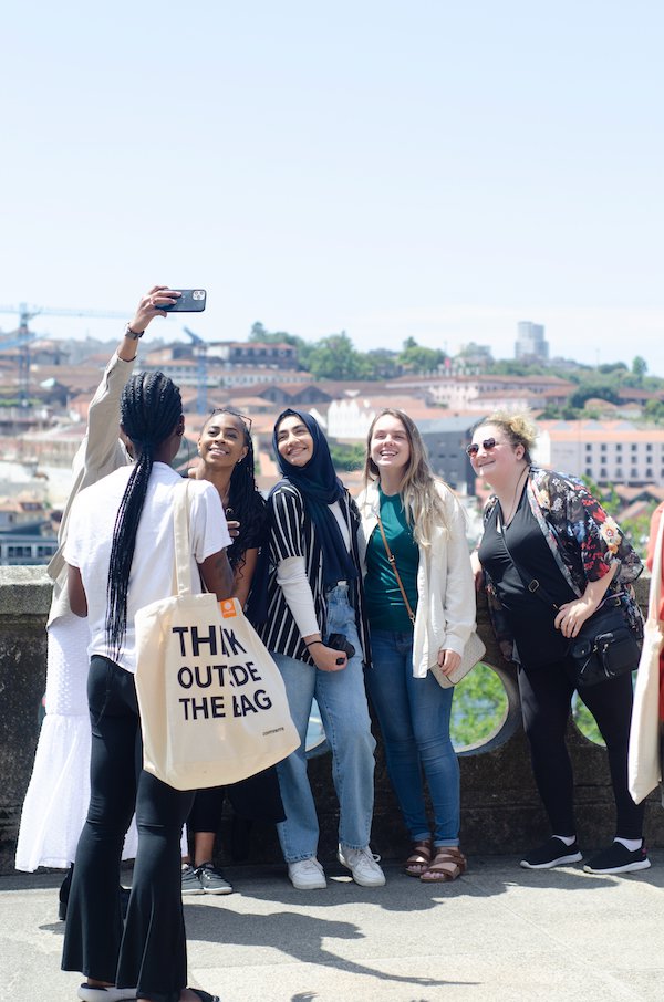 Students posing for a selfie above the Porto rooftops