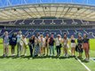 The entire group of USG Porto study abroad students on the pitch at the Dragão Stadium.